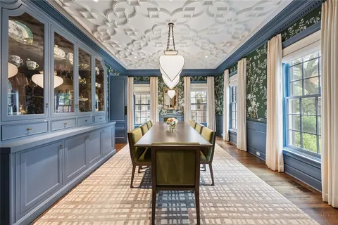 a view of a dining room with furniture large windows and wooden floor