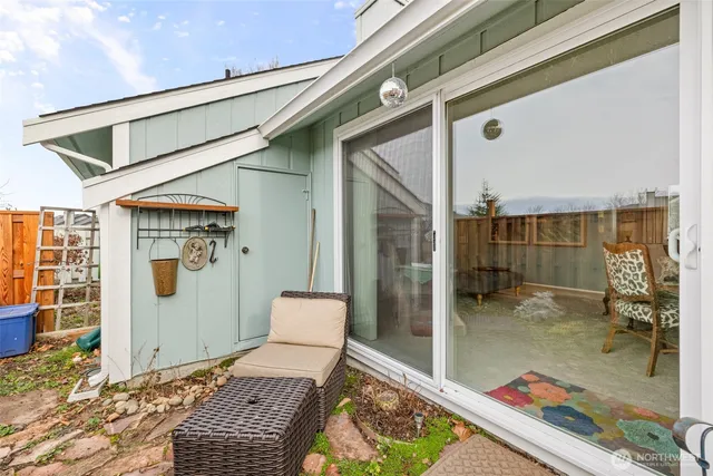 a backyard of a house with table and chairs