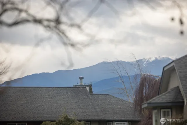 a view of a house with a yard and wooden fence