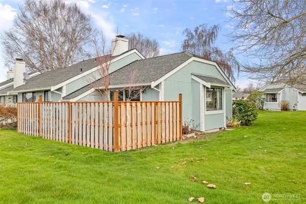 a view of a house with a yard and pathway