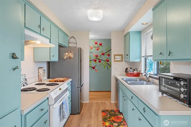 a kitchen with a white stove top oven and refrigerator
