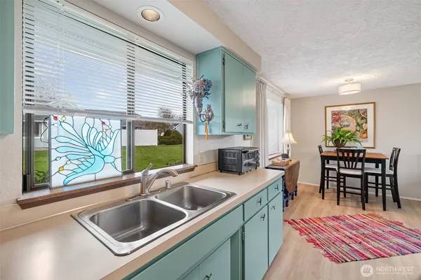 a kitchen view with a sink and living room
