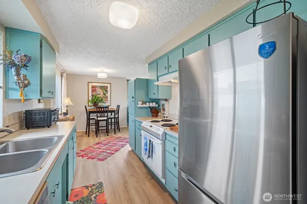 a kitchen with stainless steel appliances granite countertop a refrigerator and a sink