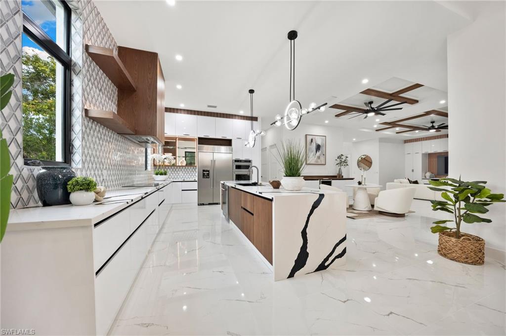 135 7th Street North Naples, FL 34102 - Photo 50 of 50 This modern contemporary masterpiece showcases a dramatic open floor plan with 4,730 square feet under air of bright, airy living space