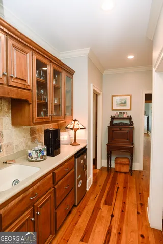 a kitchen with stainless steel appliances granite countertop a refrigerator and wooden cabinets