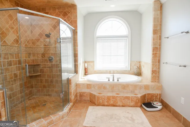 a bathroom with a tub a sink and a shower