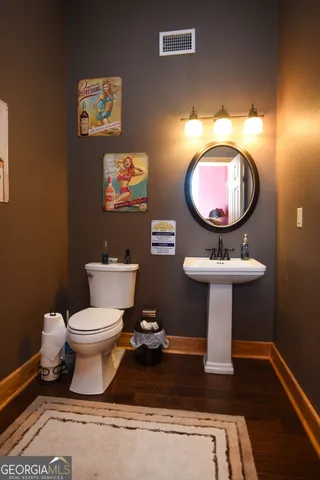 a living room with furniture and a clock