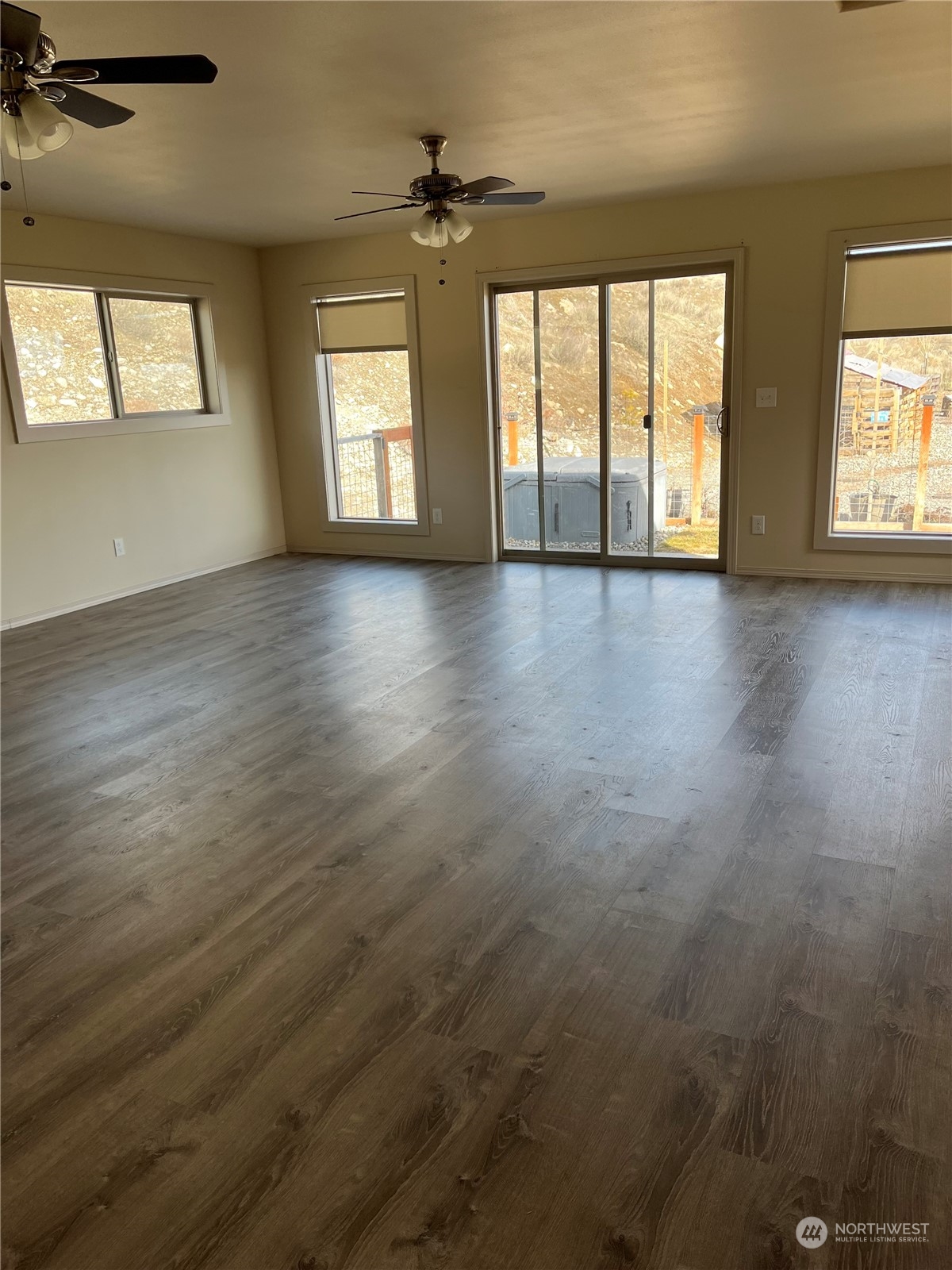 471 A Plata Road Brewster, WA 98812 - Photo 14 of 36 an empty room with wooden floor and windows