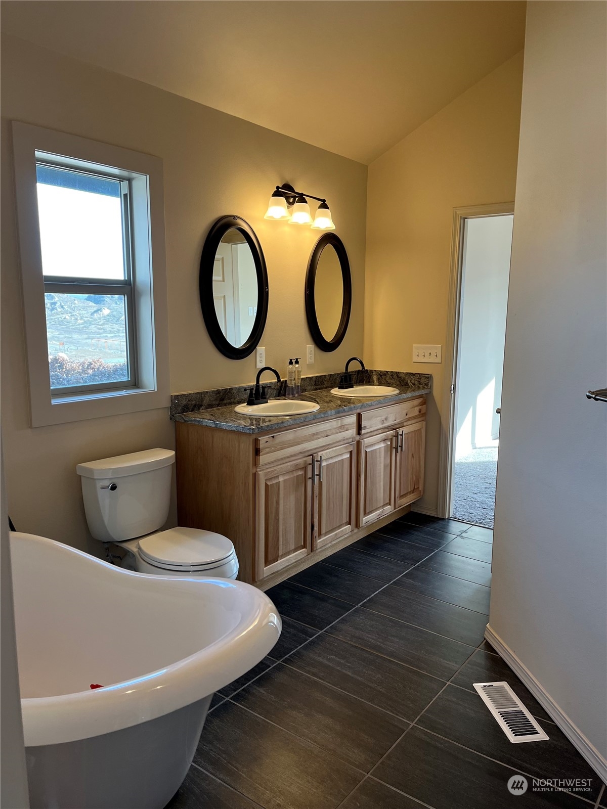 471 A Plata Road Brewster, WA 98812 - Photo 18 of 36 a bathroom with a toilet a sink and a mirror