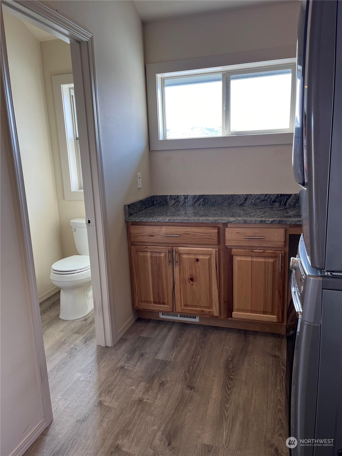 471 A Plata Road Brewster, WA 98812 - Photo 19 of 36 a view of a hallway with wooden floor and a window