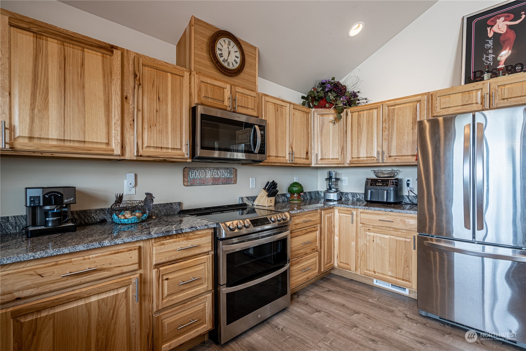 471 A Plata Road Brewster, WA 98812 - Photo 29 of 36 a kitchen with granite countertop a refrigerator a stove a microwave and cabinets