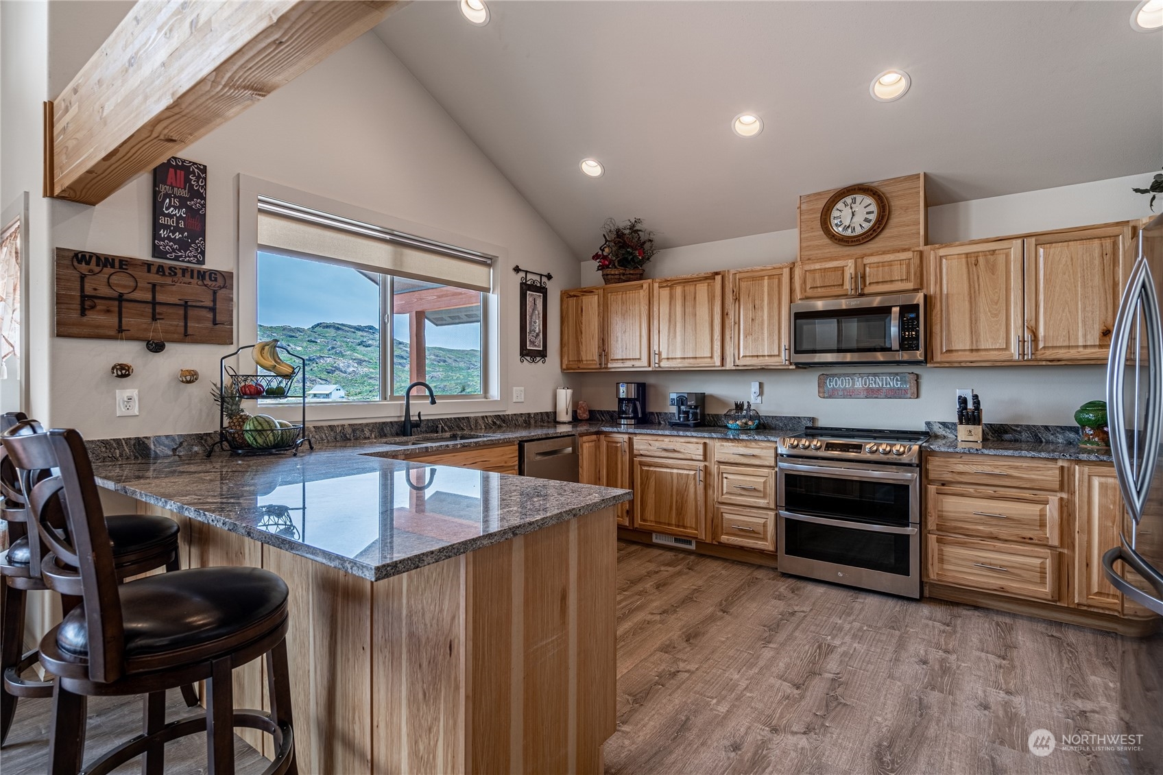 471 A Plata Road Brewster, WA 98812 - Photo 8 of 36 a kitchen with granite countertop a stove top oven a sink dishwasher and cabinets with wooden floor