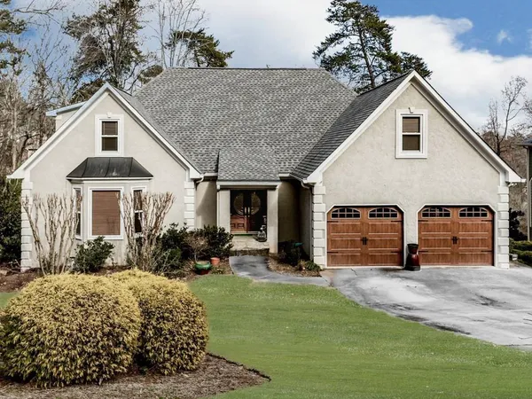 a view of a house with yard and sitting area
