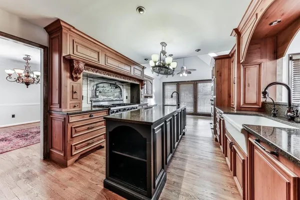a kitchen with stainless steel appliances granite countertop a sink and cabinets