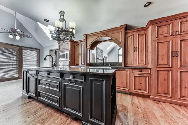 a kitchen with stainless steel appliances granite countertop a sink and cabinets