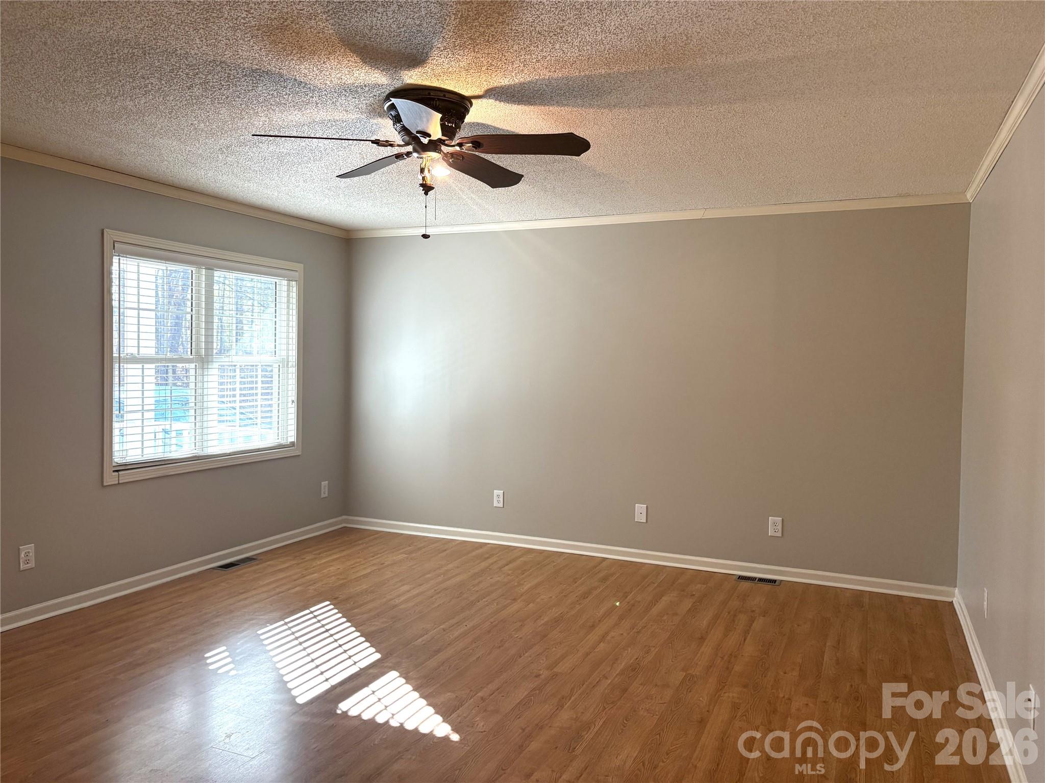 275 Holiday Road Lancaster, SC 29720 - Photo 5 of 8 a view of an empty room with a window and wooden floor