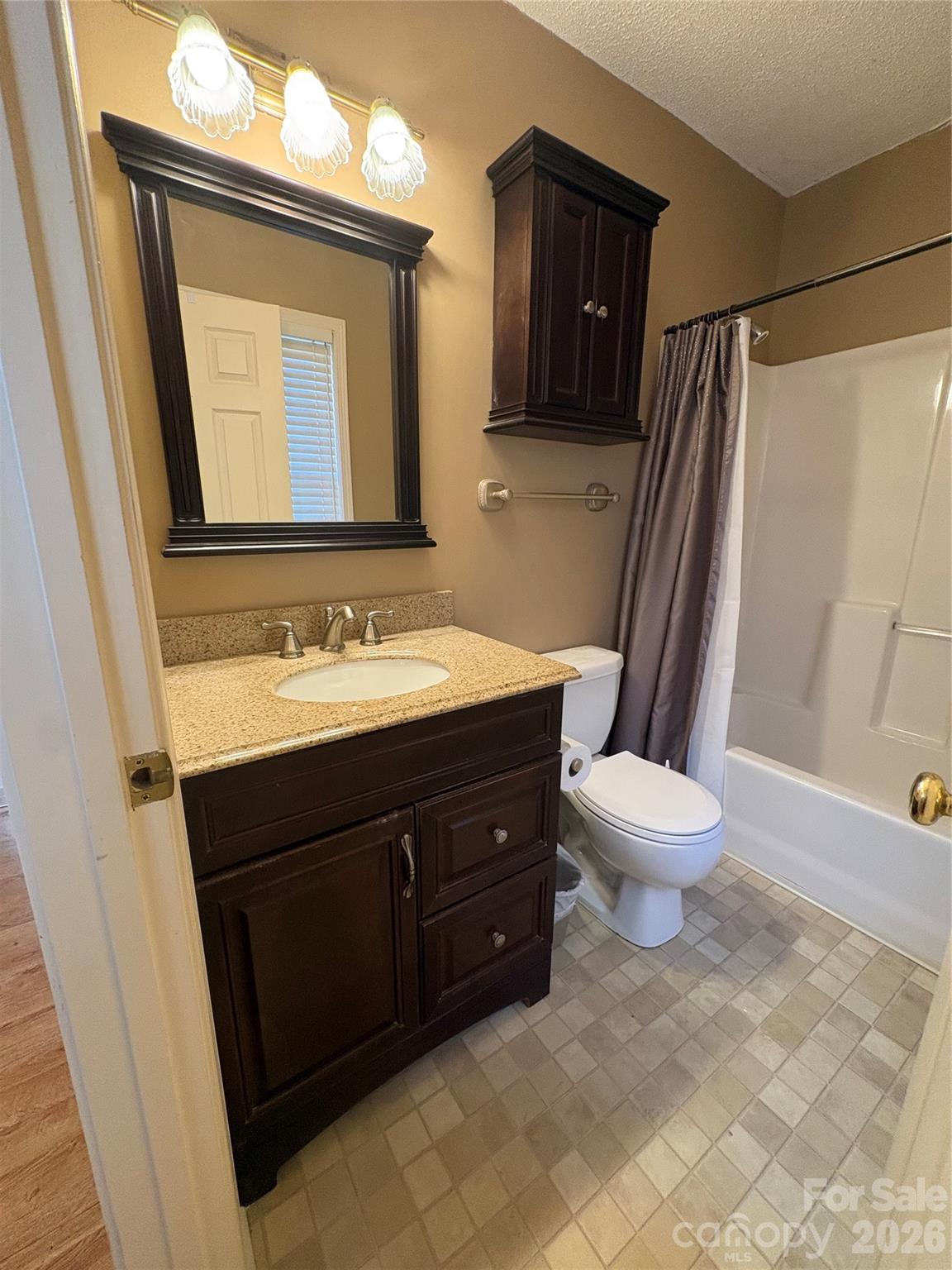 275 Holiday Road Lancaster, SC 29720 - Photo 8 of 8 a bathroom with a sink vanity granite toilet and a mirror