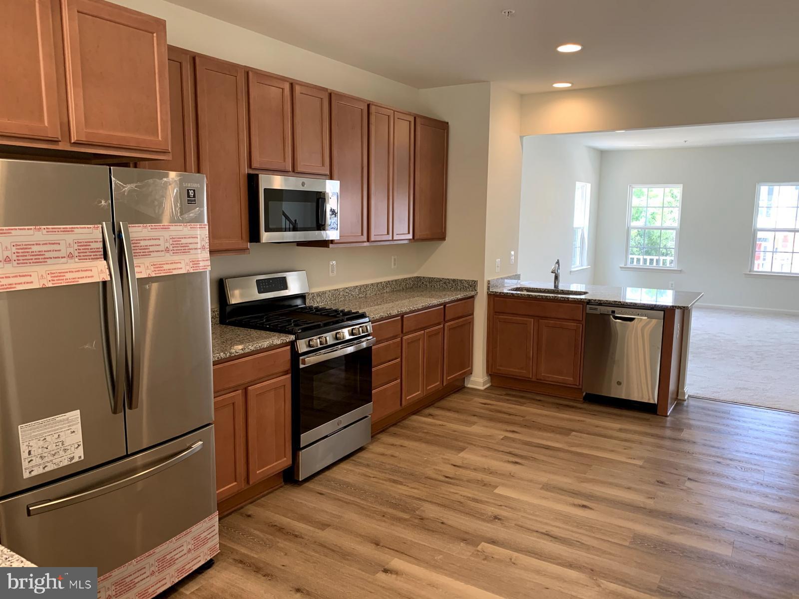 263 Trails Way Joppa, MD 21085 - Photo 2 of 27 a kitchen with stainless steel appliances granite countertop a sink stove and refrigerator