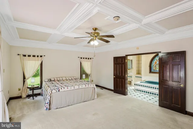 a spacious bedroom with a bed and a window