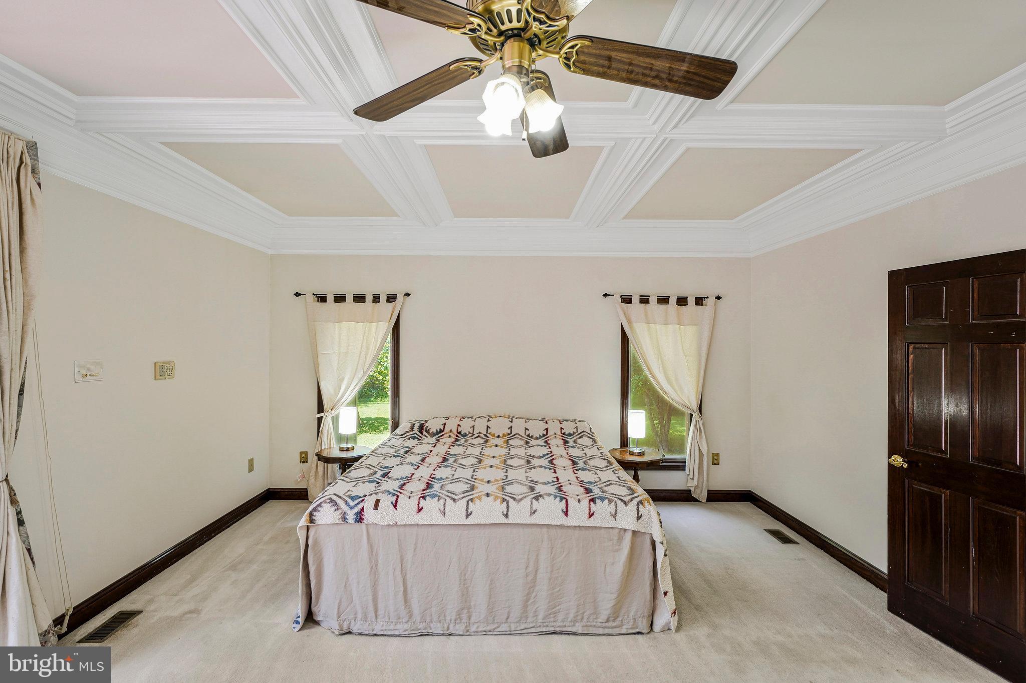 8652 Tuttle Road Springfield, VA 22152 - Photo 17 of 102 a bedroom with a bed and a chandelier