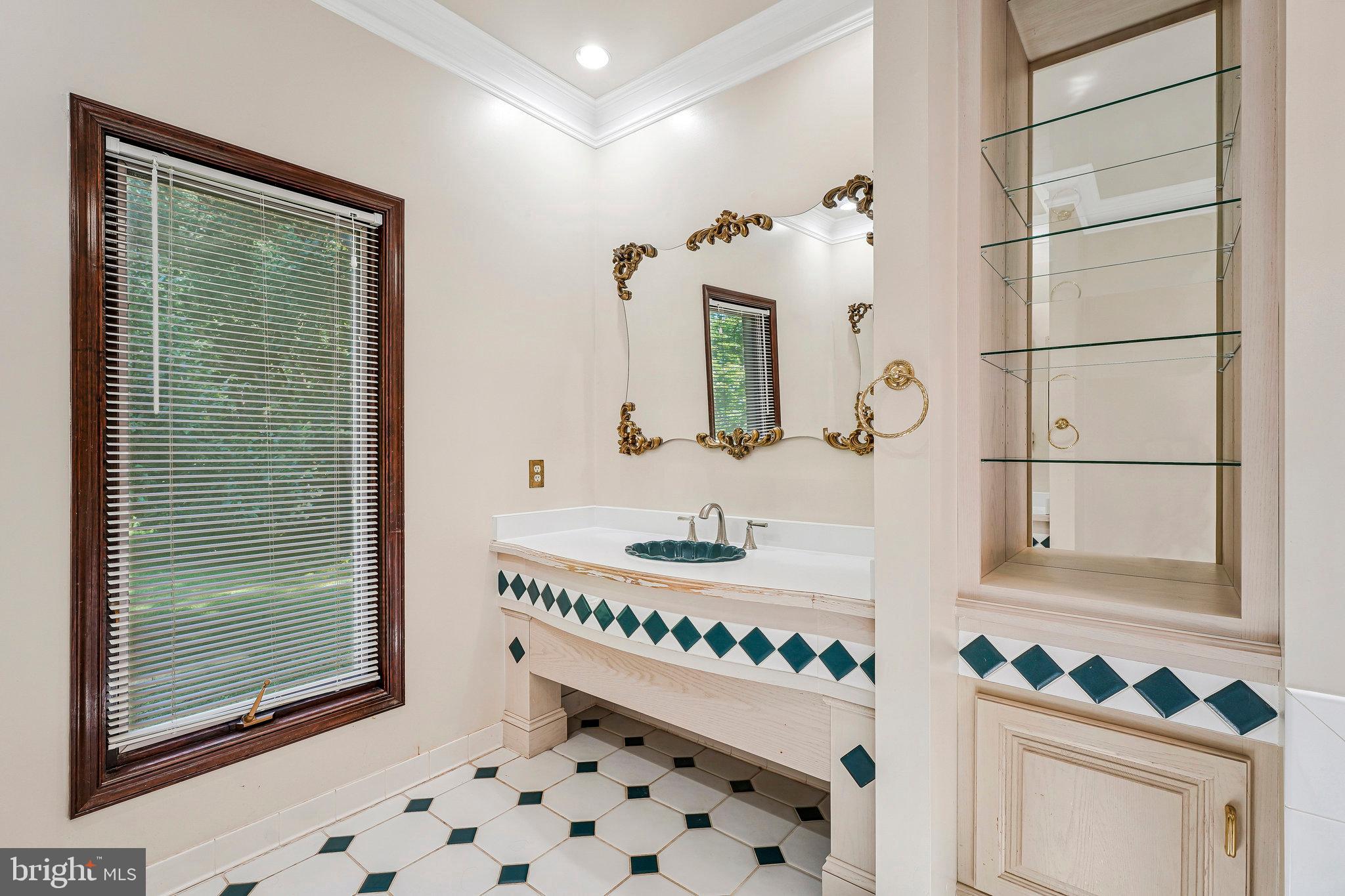 8652 Tuttle Road Springfield, VA 22152 - Photo 20 of 102 a bathroom with a sink mirror and vanity