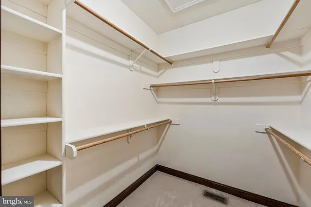 a spacious bedroom with a large bed and a large window