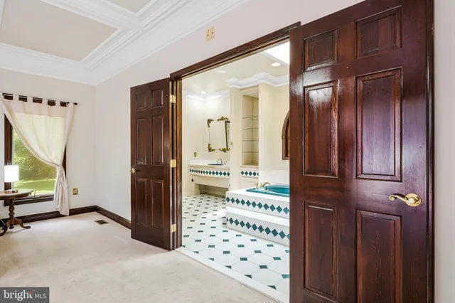 a spacious bedroom with a bed and a large window