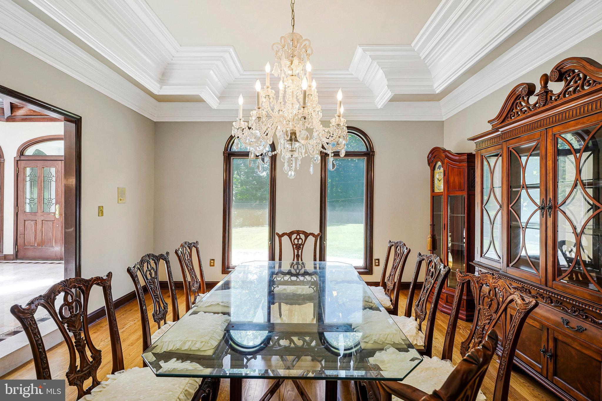 8652 Tuttle Road Springfield, VA 22152 - Photo 29 of 102 a view of a dining room with furniture a chandelier and wooden floor