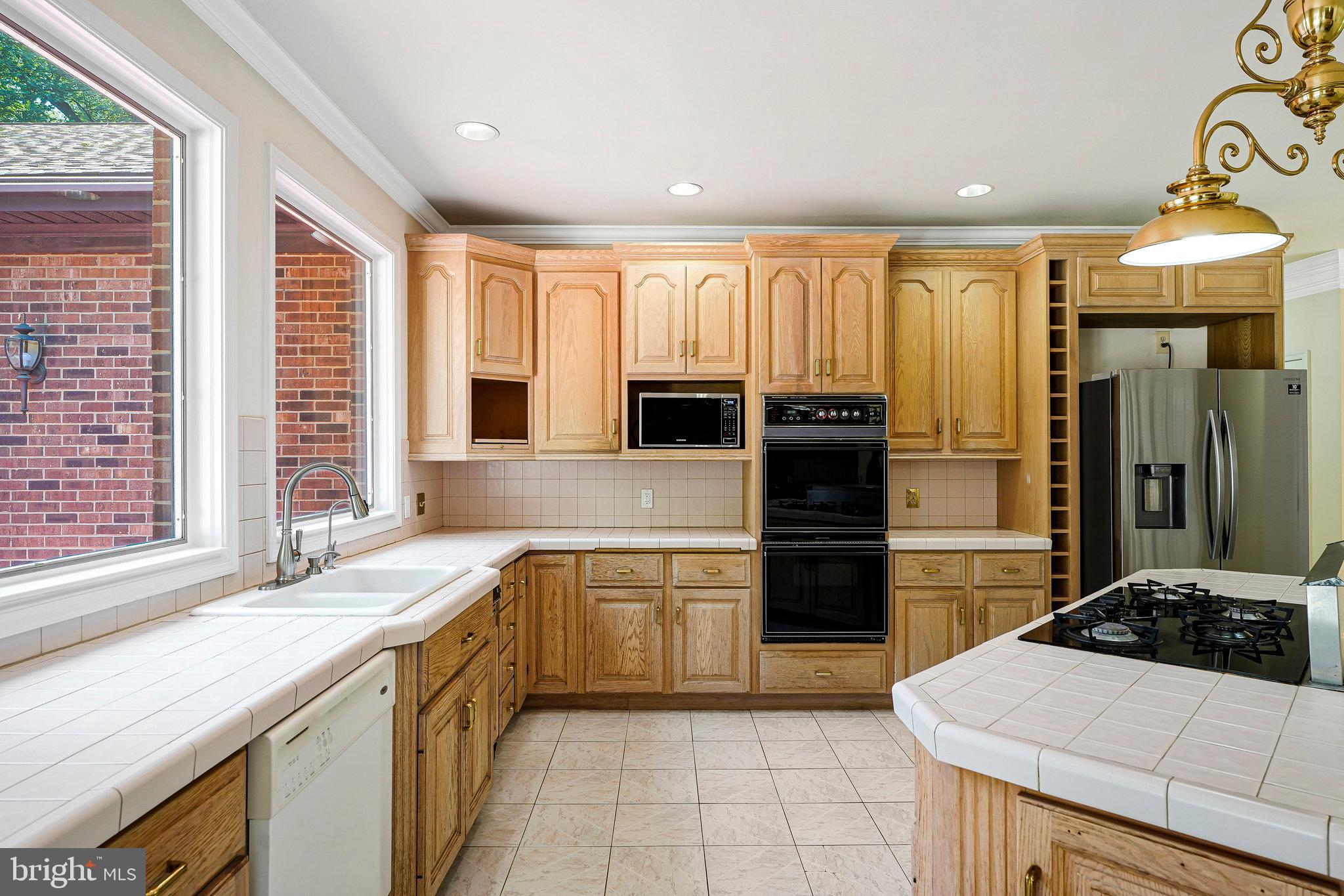 8652 Tuttle Road Springfield, VA 22152 - Photo 3 of 102 a kitchen with a refrigerator and a sink