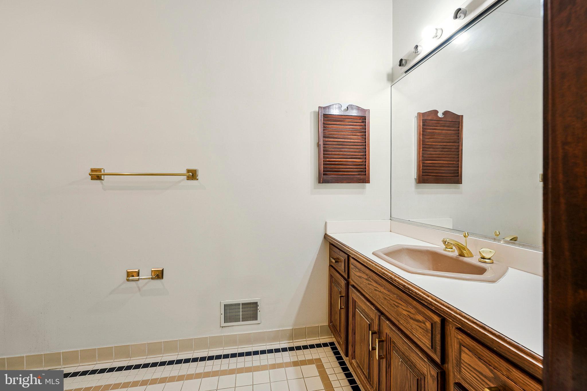8652 Tuttle Road Springfield, VA 22152 - Photo 42 of 102 a bathroom with a sink and a mirror