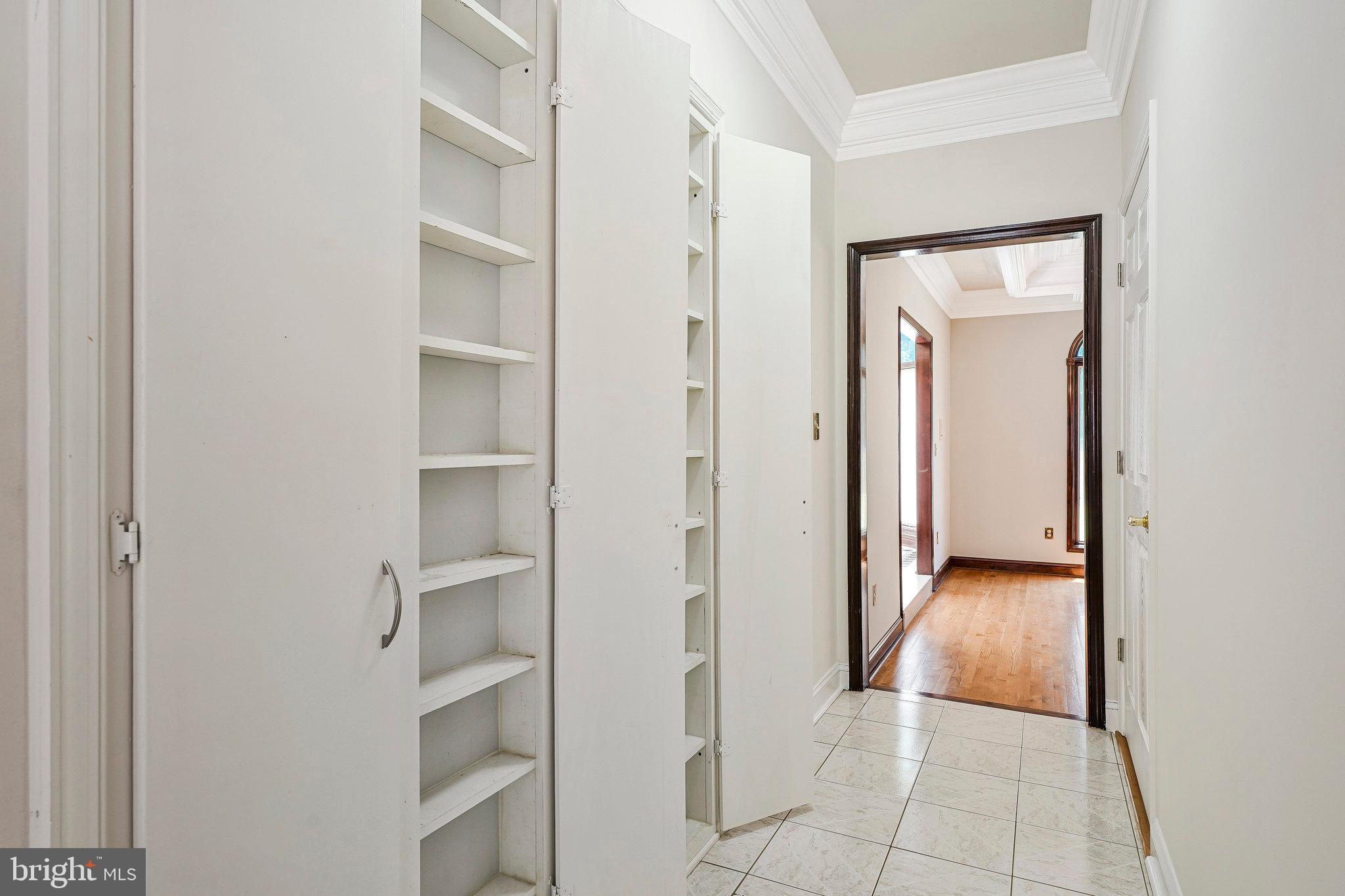 8652 Tuttle Road Springfield, VA 22152 - Photo 49 of 102 a view of a hallway with wooden floor