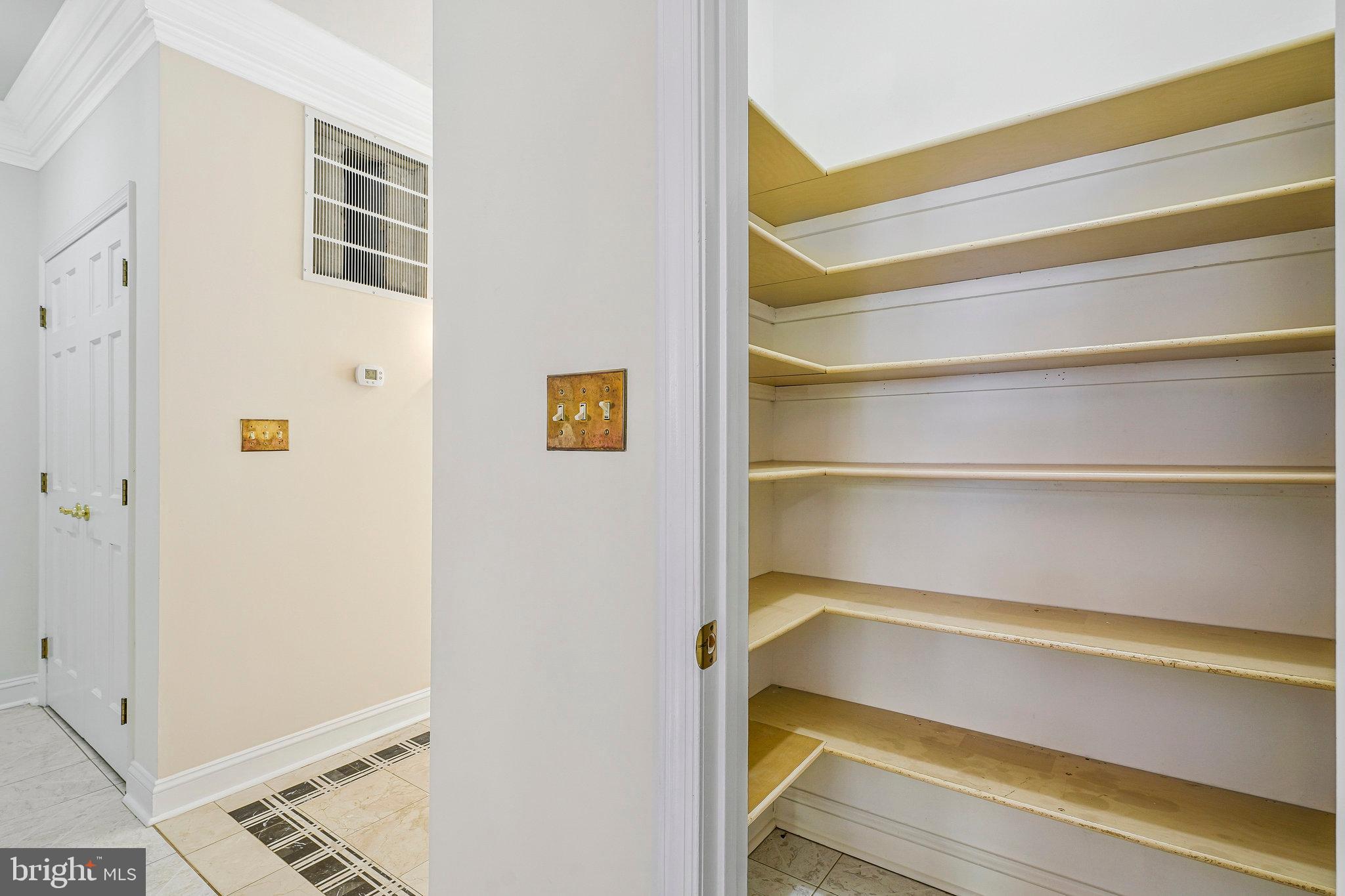 8652 Tuttle Road Springfield, VA 22152 - Photo 50 of 102 a view of walk in closet with empty racks