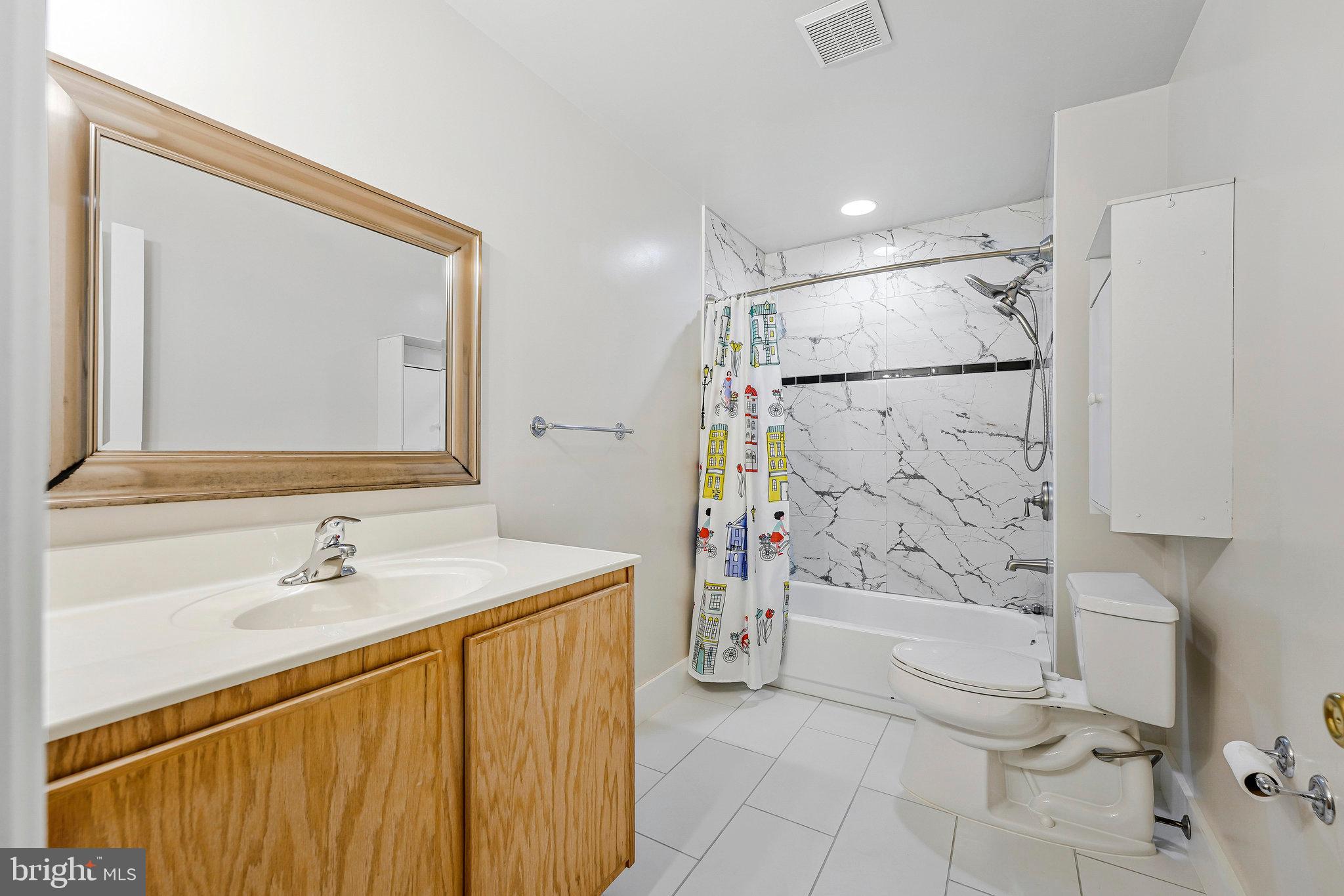 8652 Tuttle Road Springfield, VA 22152 - Photo 53 of 102 a bathroom with a sink a toilet and shower