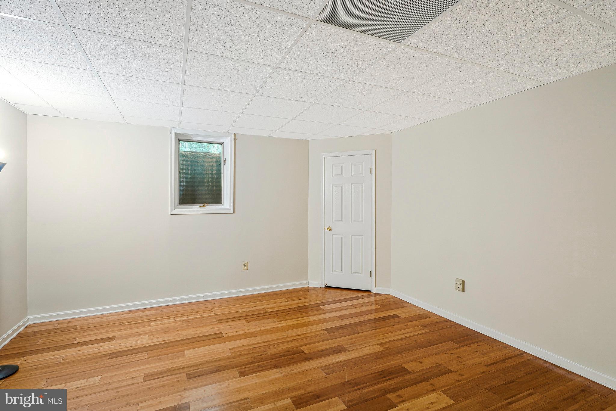8652 Tuttle Road Springfield, VA 22152 - Photo 54 of 102 a view of a room with wooden floor and fan