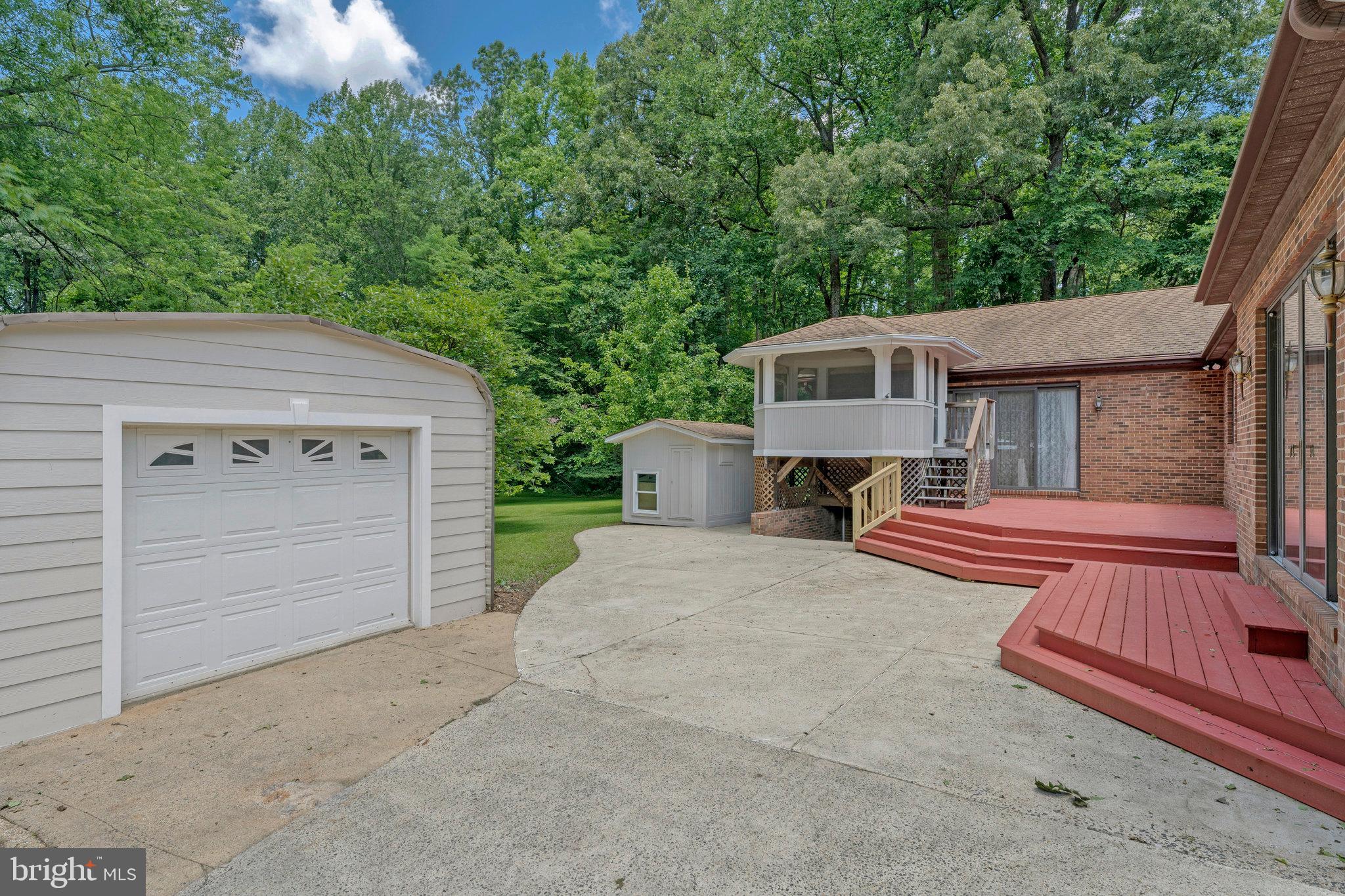 8652 Tuttle Road Springfield, VA 22152 - Photo 82 of 102 a front view of a house with a yard and garage