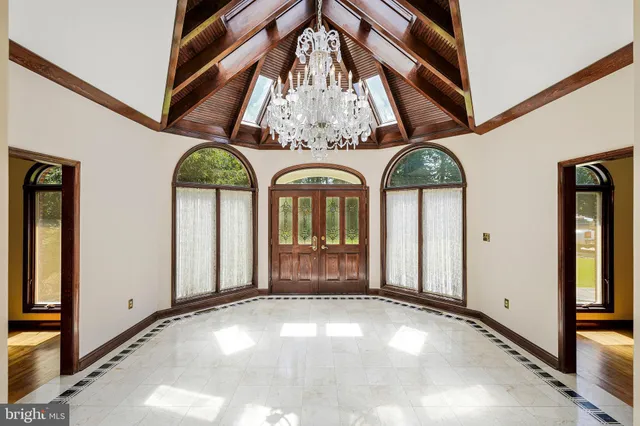 a view of a dining room with furniture and chandelier