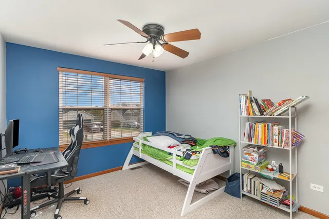 a bedroom with a bed and a book shelf