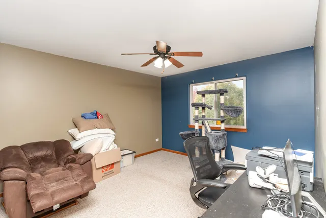 a view of a workspace with furniture and chandelier