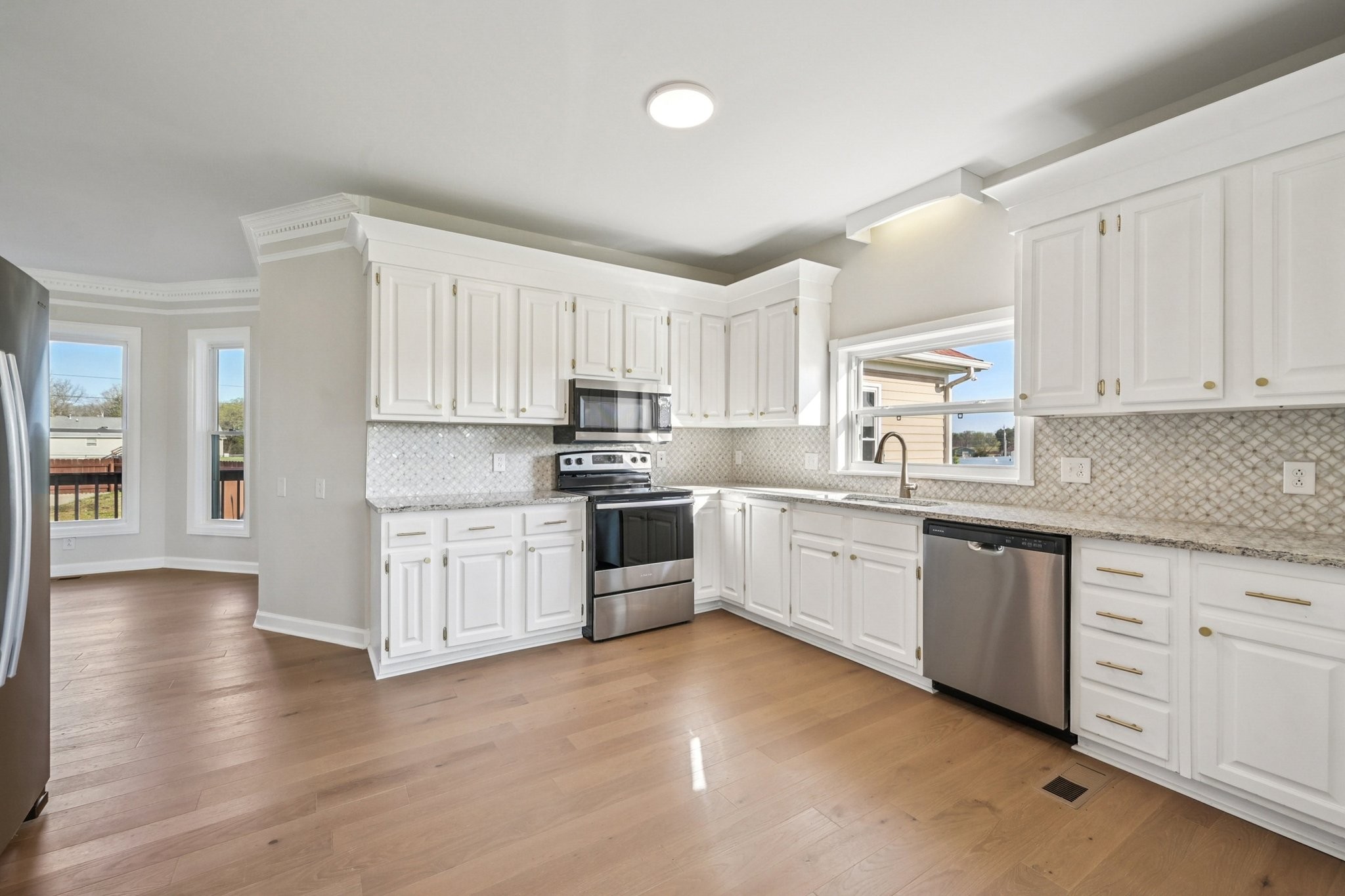 3032 Highway 49 Pleasant View, TN 37146 - Photo 5 of 19 a kitchen with granite countertop white cabinets and white appliances