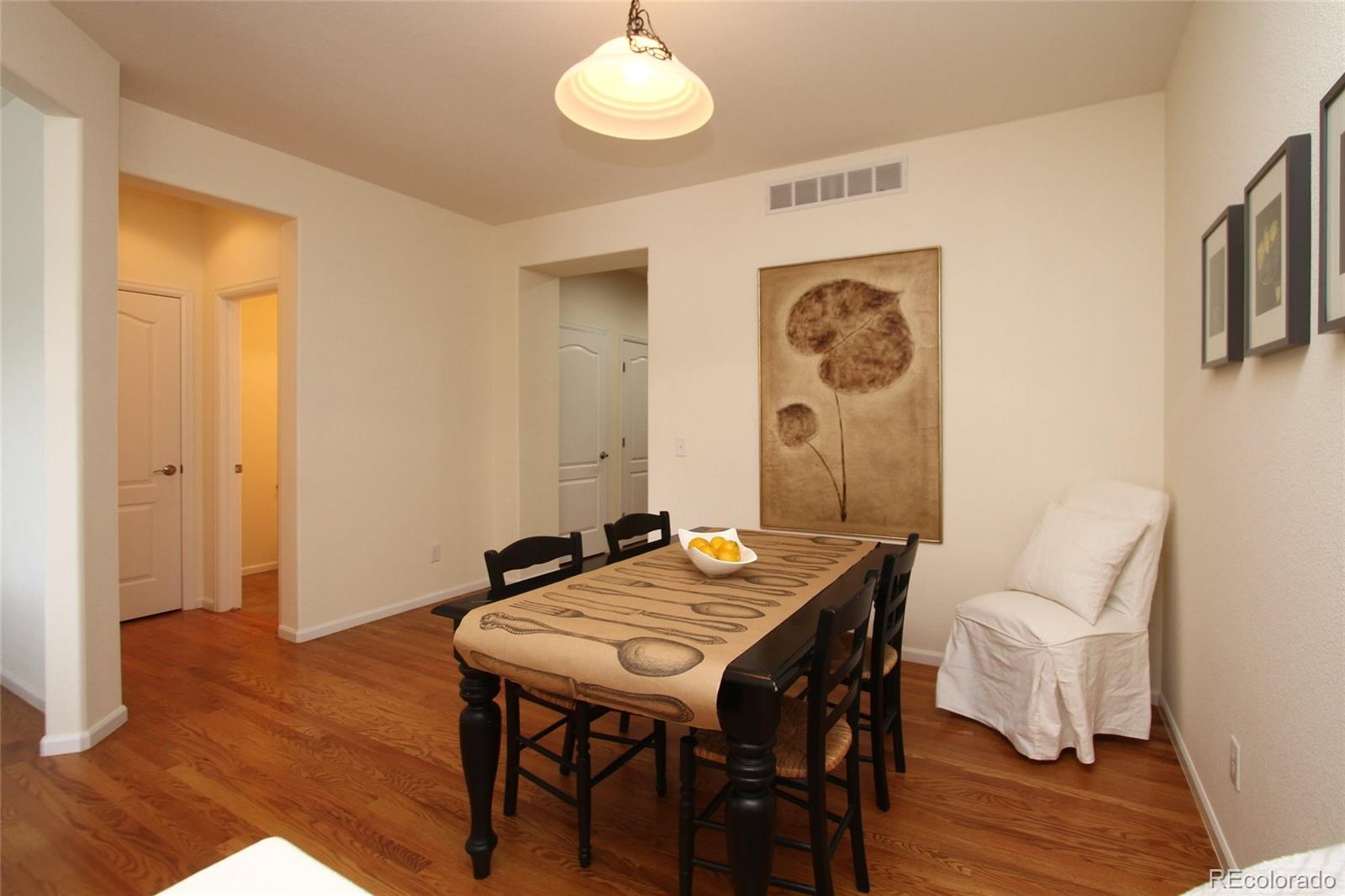 9489 Cedarhurst Lane, Unit B Highlands Ranch, CO 80129 - Photo 11 of 20 a view of a dining room with furniture and wooden floor