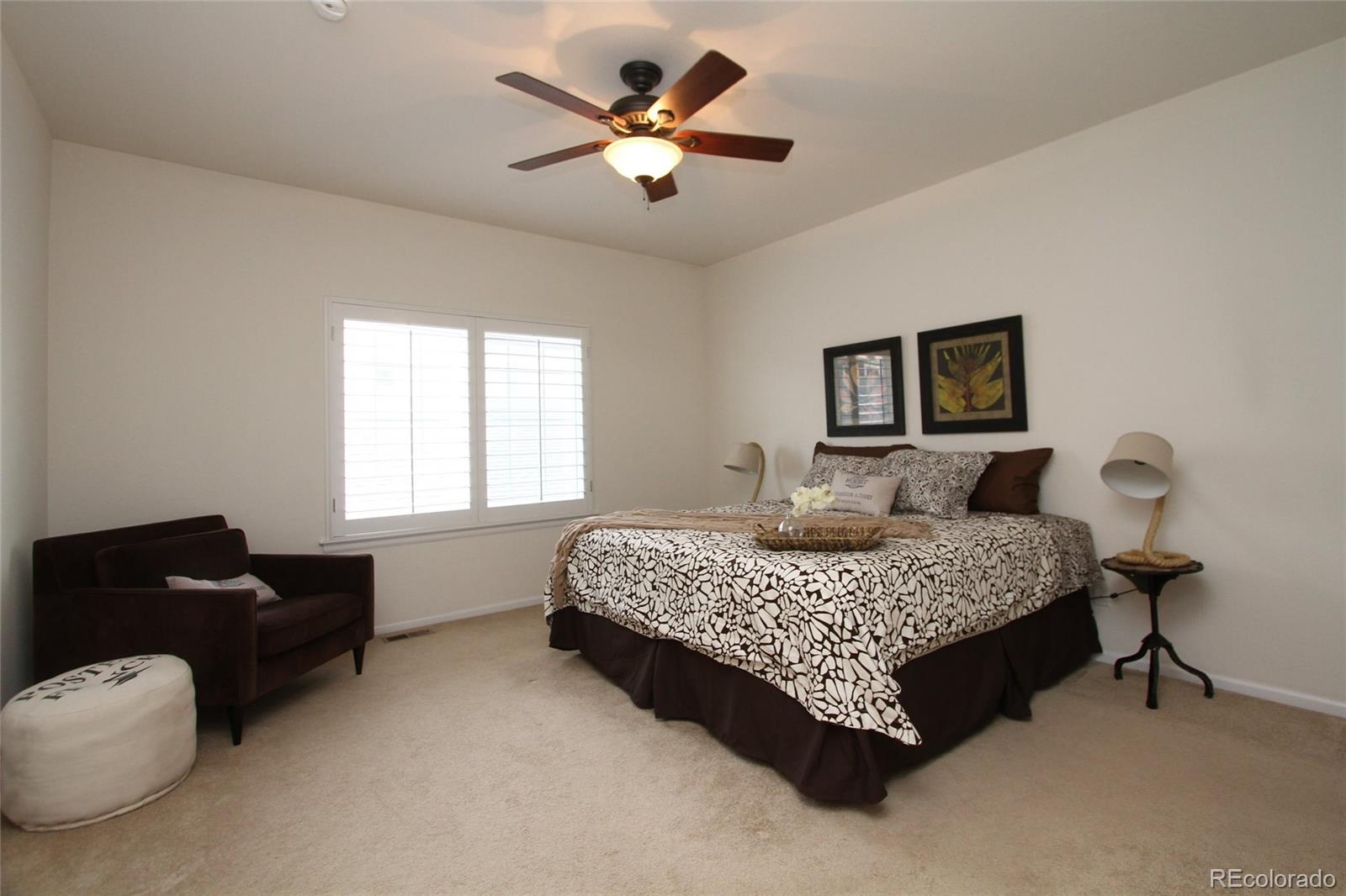 9489 Cedarhurst Lane, Unit B Highlands Ranch, CO 80129 - Photo 14 of 20 a bedroom with a bed and furniture