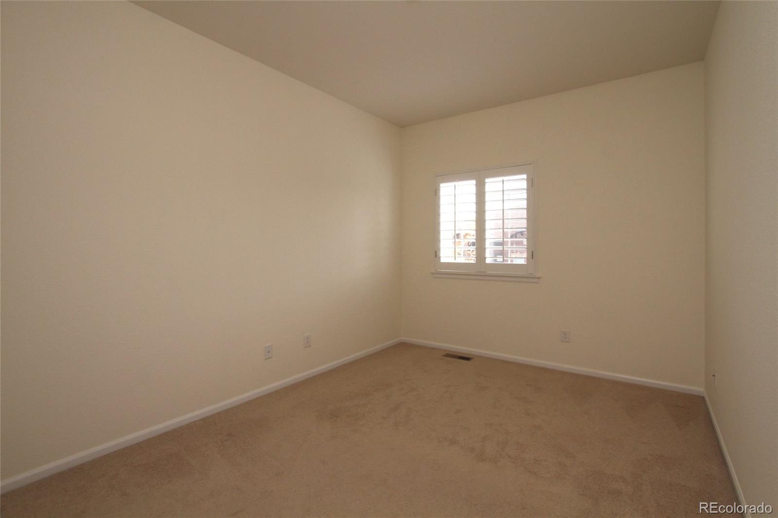9489 Cedarhurst Lane, Unit B Highlands Ranch, CO 80129 - Photo 17 of 20 an empty room with a window