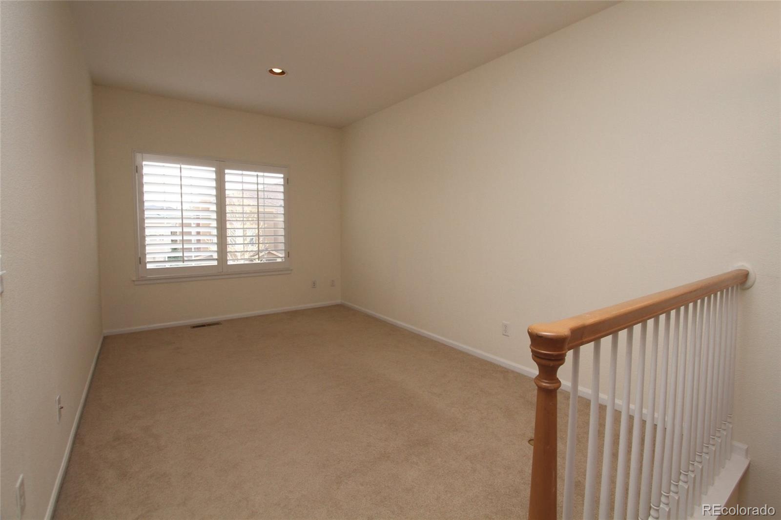 9489 Cedarhurst Lane, Unit B Highlands Ranch, CO 80129 - Photo 18 of 20 a view of an empty room with a window