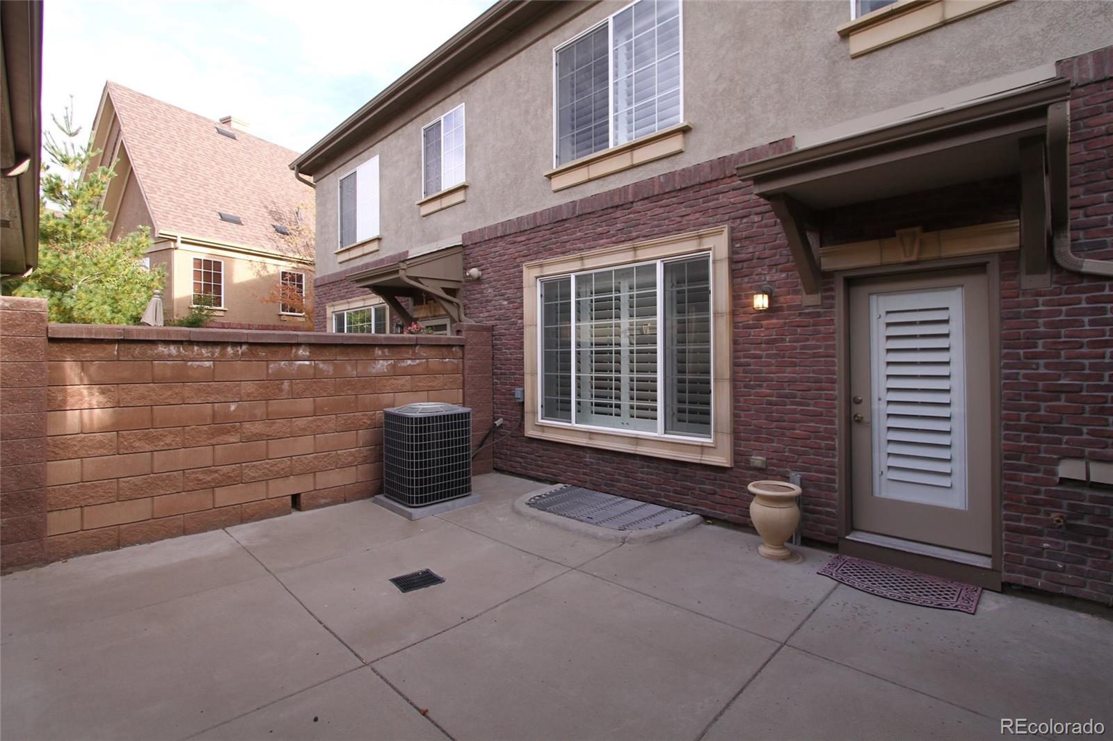 9489 Cedarhurst Lane, Unit B Highlands Ranch, CO 80129 - Photo 20 of 20 a front view of a house with outdoor space