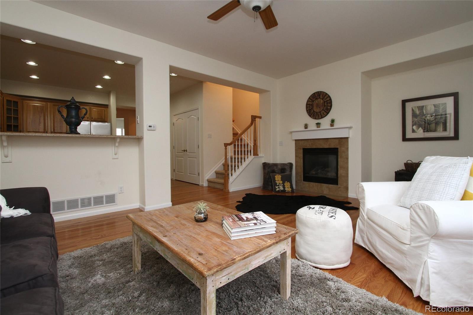 9489 Cedarhurst Lane, Unit B Highlands Ranch, CO 80129 - Photo 3 of 20 a living room with furniture and a fireplace