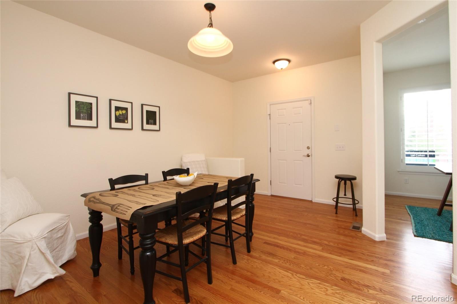 9489 Cedarhurst Lane, Unit B Highlands Ranch, CO 80129 - Photo 10 of 20 a view of a dining room with furniture and wooden floor