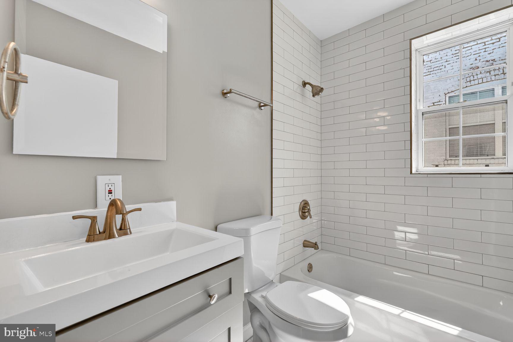 1008 Rittenhouse Street Northwest, Unit 15 Washington, DC 20011 - Photo 26 of 39 a bathroom with a sink a toilet and shower