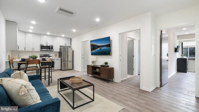 a living room with furniture and a flat screen tv