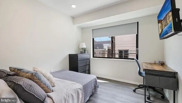 a bedroom with a bed and a window