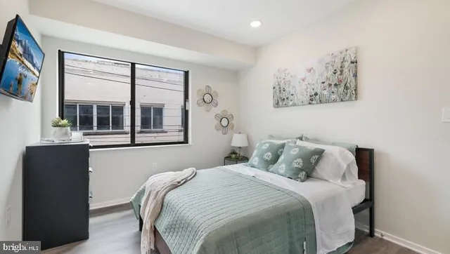 a bedroom with a bed and a window